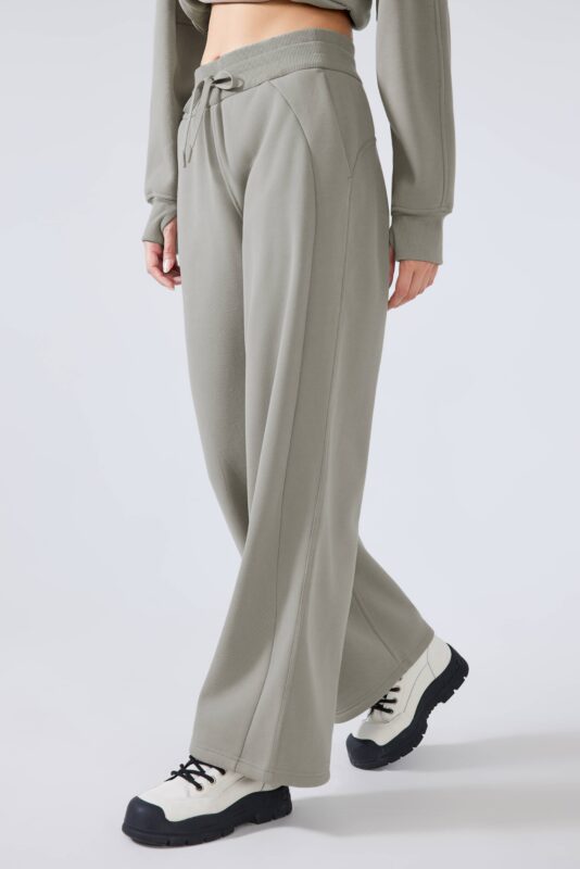 A close-up view of the premium fleece fabric used in our athletic pants, highlighting the soft and plush texture that ensures long-lasting warmth and comfort. This high-quality material is perfect for businesses seeking durable and comfortable athleisure wear for their customers. The natural smooth outer layer and soft inner fleece make these pants ideal for various applications.